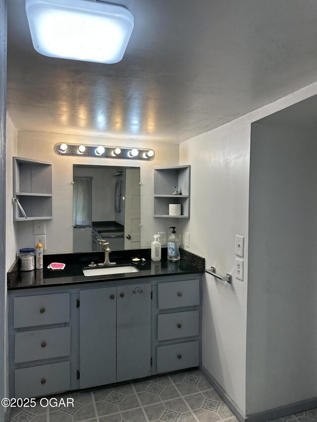 110 E Russell St, Goodman, MO 64843 - bathroom with vanity, baseboards, and tile patterned floors
