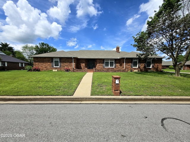 2921 E Matthews Dr, Joplin, MO 64801 - ranch-style house featuring a chimney, a shingled roof, brick siding, and a front yard
