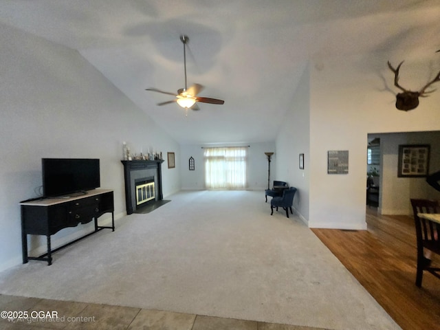 2921 E Matthews Dr, Joplin, MO 64801 - living area featuring ceiling fan, a fireplace, carpet floors, high vaulted ceiling, and baseboards