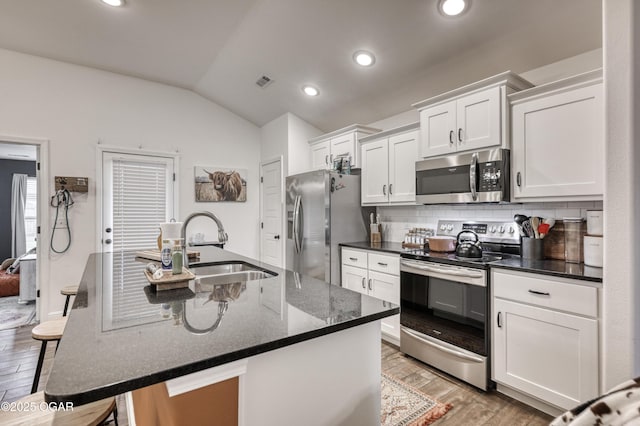 354 Sidney Ln, Webb City, MO 64870 - kitchen with a kitchen bar, appliances with stainless steel finishes, a sink, light wood finished floors, and lofted ceiling