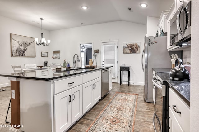 354 Sidney Ln, Webb City, MO 64870 - kitchen with appliances with stainless steel finishes, white cabinets, a breakfast bar area, and a center island with sink