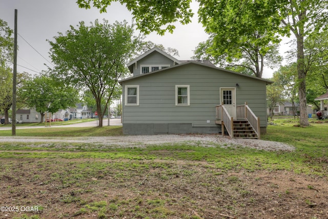 back of house featuring a yard