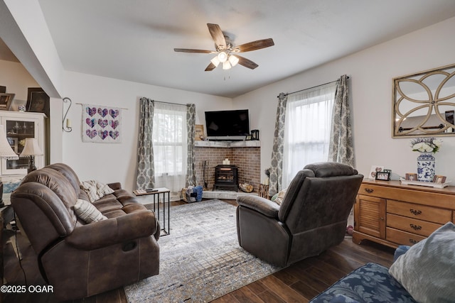 living room featuring a ceiling fan and wood finished floors