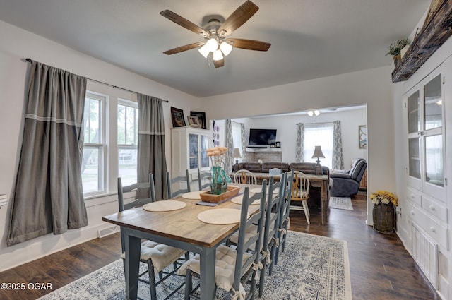 dining room featuring ceiling fan, visible vents, and dark wood-style floors