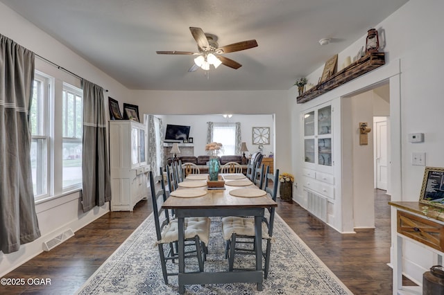 dining area with ceiling fan, dark wood finished floors, and visible vents