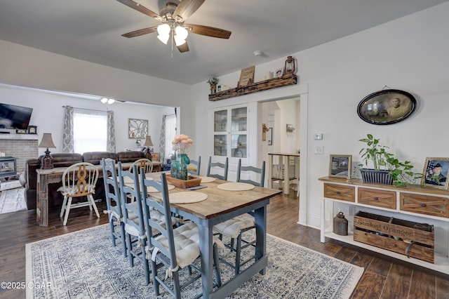 dining area with a ceiling fan and wood finished floors