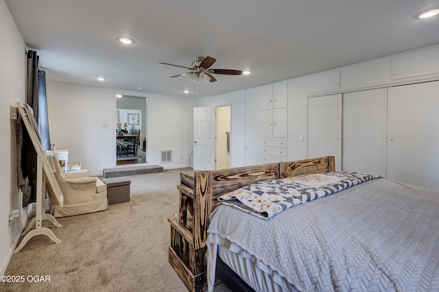 carpeted bedroom featuring visible vents, recessed lighting, baseboards, and a ceiling fan