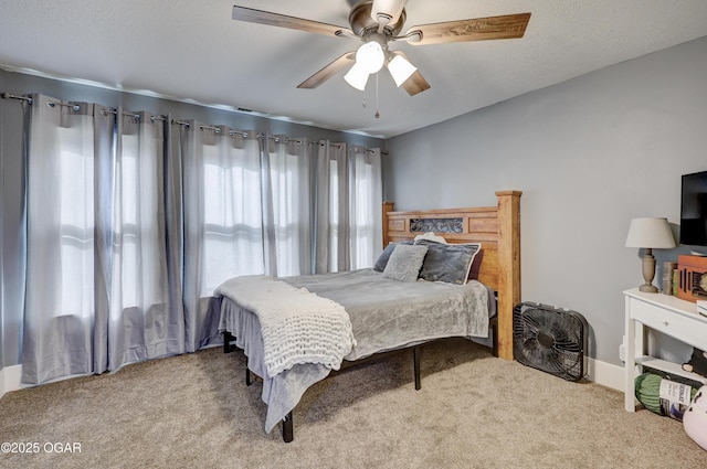 bedroom featuring a ceiling fan and carpet