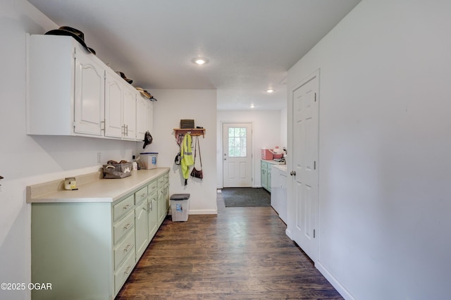 interior space featuring recessed lighting, baseboards, and dark wood finished floors