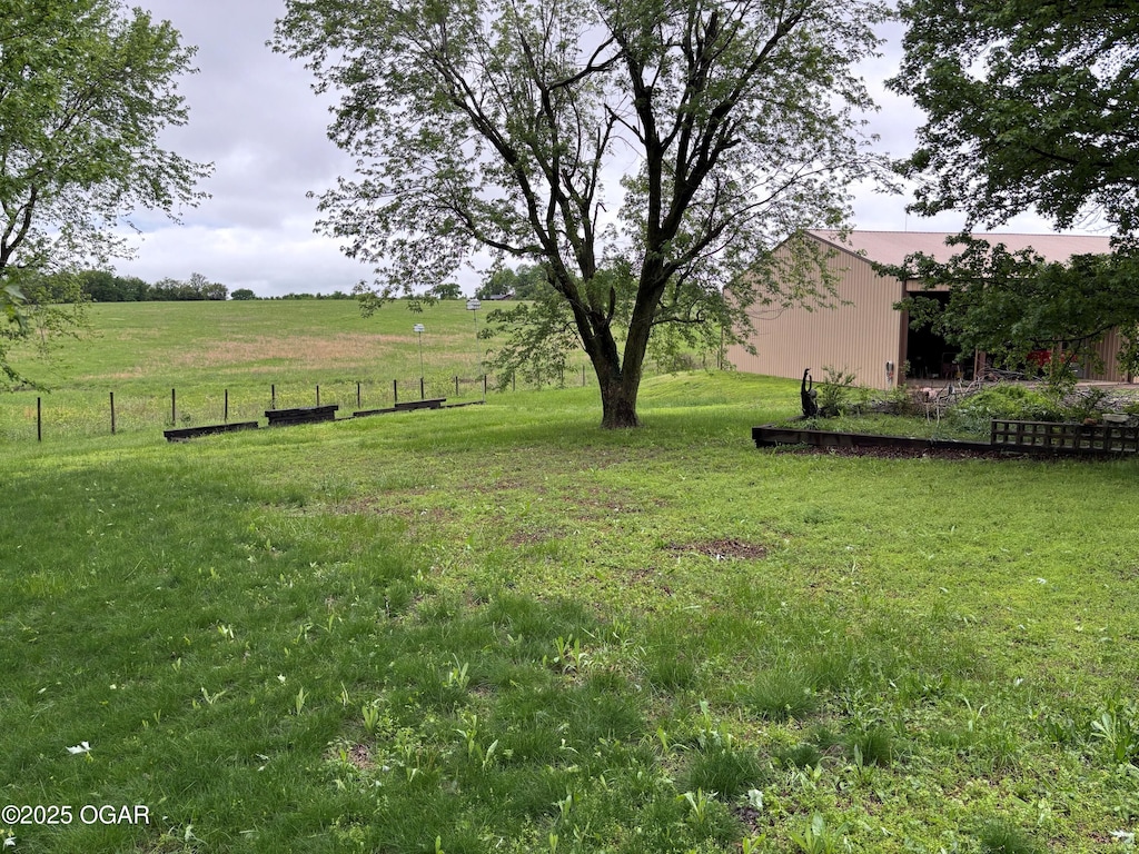 1208 S Blackcat Rd, Joplin, MO 64801 - view of yard with a pole building, fence, an outbuilding, and a rural view