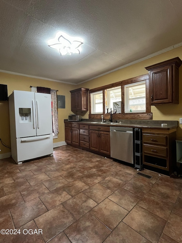 1715 S Kentucky Ave, Joplin, MO 64804 - kitchen with white fridge with ice dispenser, dishwasher, dark countertops, ornamental molding, and a sink
