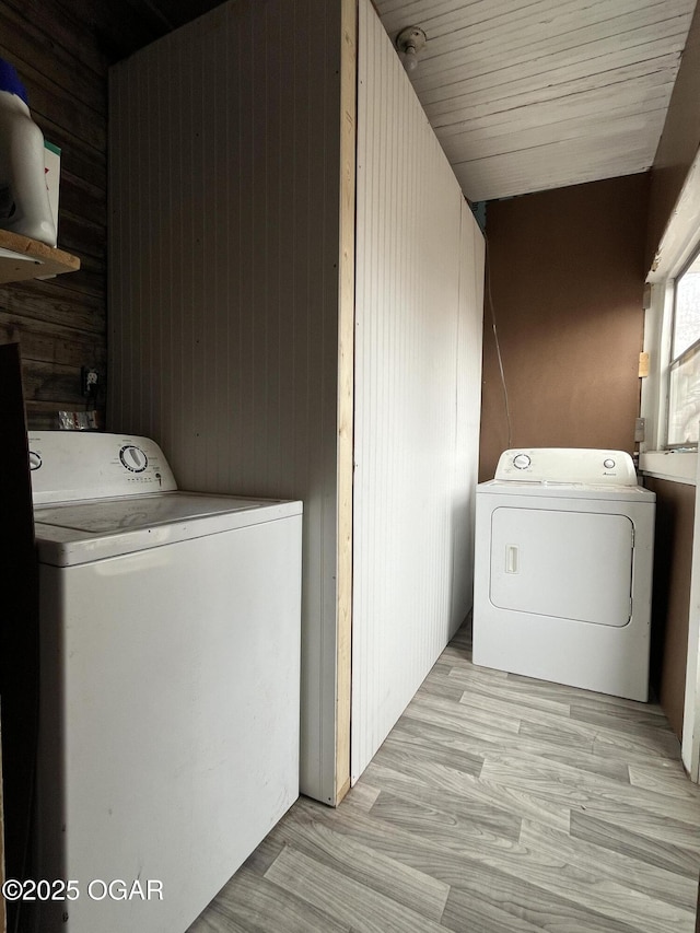 1715 S Kentucky Ave, Joplin, MO 64804 - laundry room with separate washer and dryer, wood walls, and light wood-style floors