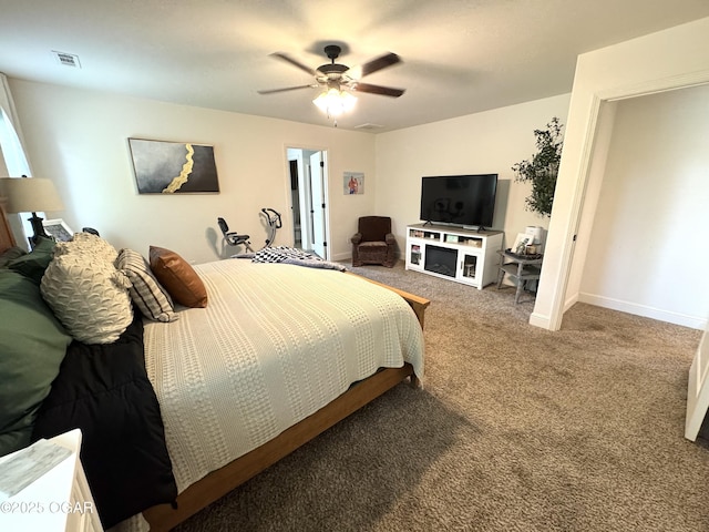 carpeted bedroom featuring visible vents, a ceiling fan, and baseboards
