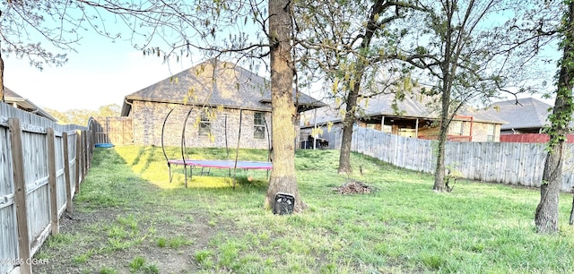 716 Kara Ln, Carl Junction, MO 64834 - view of yard featuring a fenced backyard and a trampoline