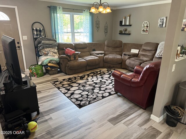 living area featuring a healthy amount of sunlight, ornamental molding, and light wood finished floors