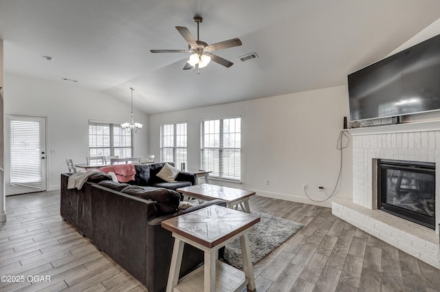 1810 Boyer Pl, Webb City, MO 64870 - living room with lofted ceiling, light wood finished floors, ceiling fan, a chandelier, and a fireplace