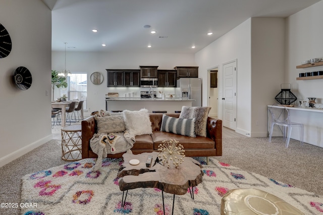 living room with baseboards, recessed lighting, and light colored carpet