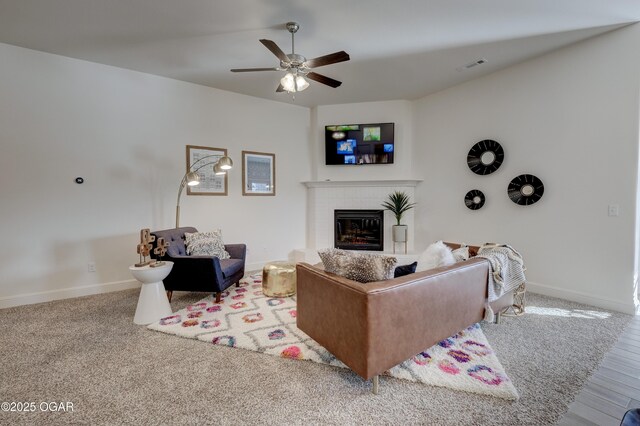 1814 Fountain Rd, Webb City, MO 64870 - living room featuring ceiling fan, a brick fireplace, baseboards, wood finished floors, and visible vents