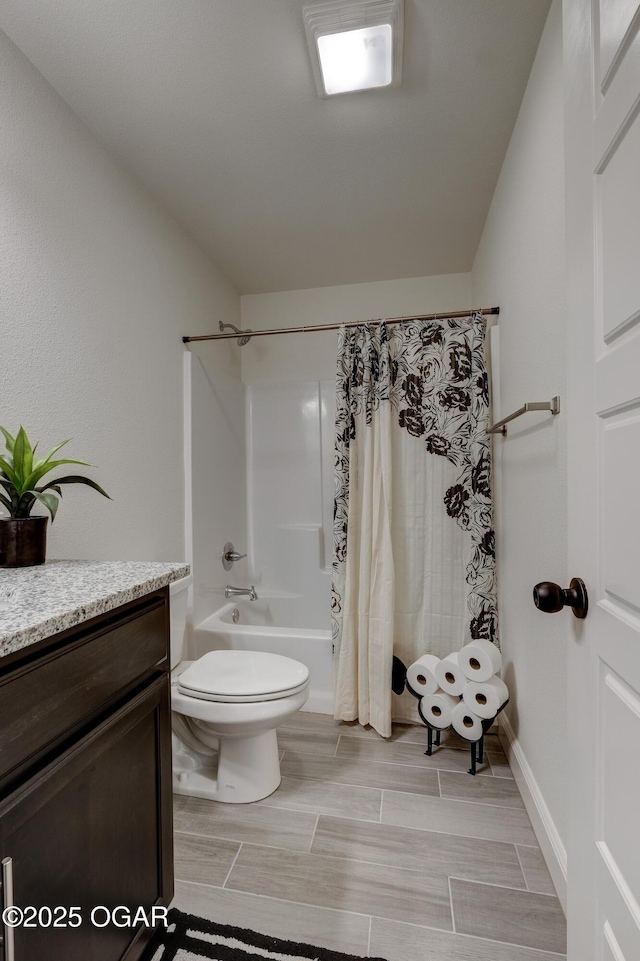 bathroom featuring vanity, wood tiled floor, shower / bath combo, and toilet