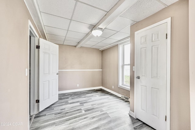 530 N Joplin Ave, Joplin, MO 64801 - unfurnished room featuring baseboards, a paneled ceiling, wood finished floors, and visible vents