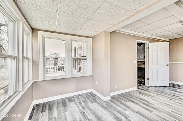 530 N Joplin Ave, Joplin, MO 64801 - empty room with wood finished floors, baseboards, and a drop ceiling