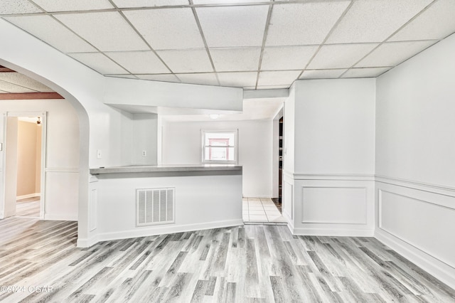 530 N Joplin Ave, Joplin, MO 64801 - spare room featuring arched walkways, visible vents, a paneled ceiling, and light wood-style floors