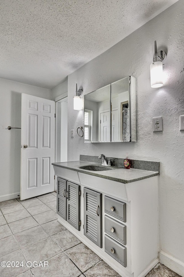 530 N Joplin Ave, Joplin, MO 64801 - bathroom with vanity, a textured wall, tile patterned flooring, and a textured ceiling