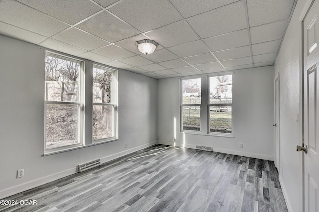530 N Joplin Ave, Joplin, MO 64801 - spare room featuring a paneled ceiling, wood finished floors, and visible vents
