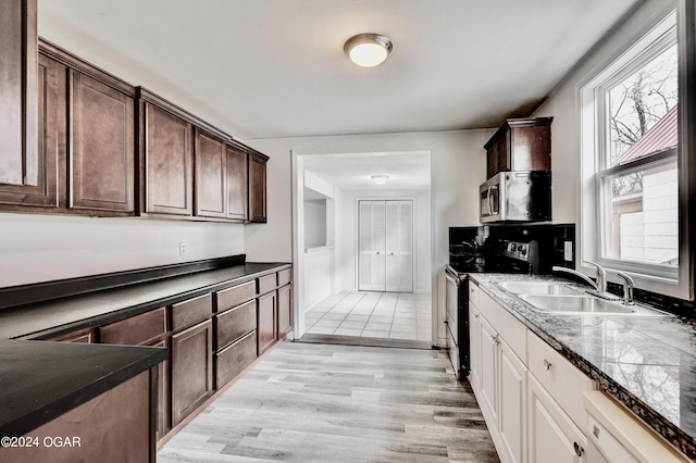 530 N Joplin Ave, Joplin, MO 64801 - kitchen featuring dark brown cabinets, a sink, light wood finished floors, electric stove, and stainless steel microwave