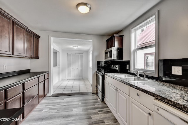530 N Joplin Ave, Joplin, MO 64801 - kitchen featuring stainless steel appliances, dark countertops, dark brown cabinetry, and a sink