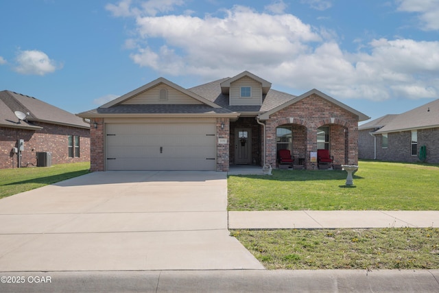 view of front of home with central AC, driveway, a garage, a front lawn, and brick siding