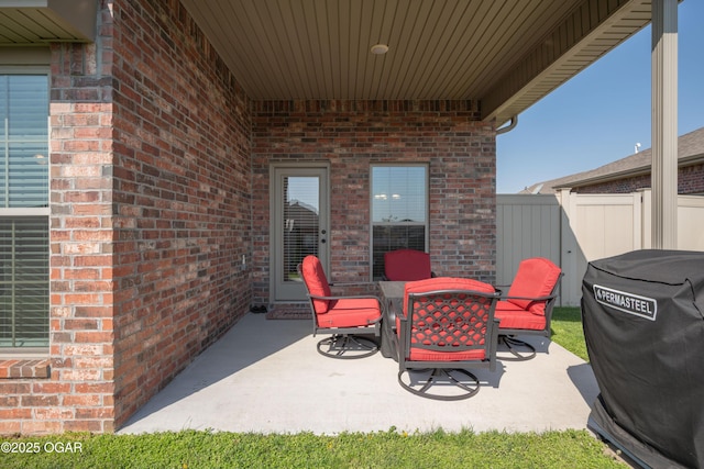 view of patio with fence, outdoor dining space, and area for grilling