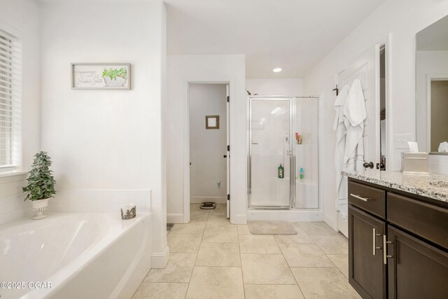 full bath with a shower stall, vanity, tile patterned floors, and a bath