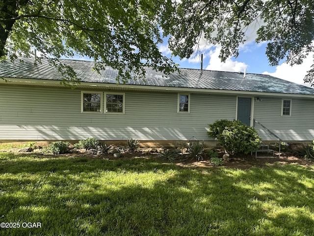 1793 8000th Rd, Oswego, KS 67356 - back of house featuring metal roof, a yard, and entry steps