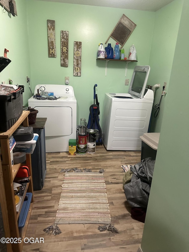 1793 8000th Rd, Oswego, KS 67356 - washroom with laundry area, washer and clothes dryer, and wood finished floors