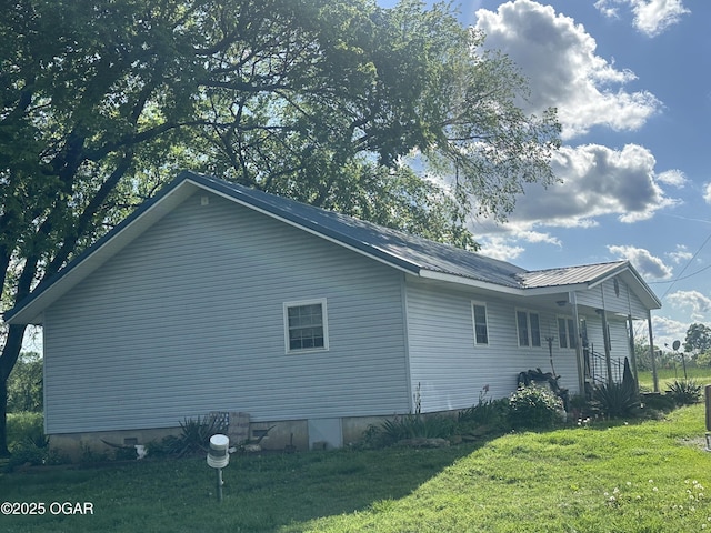 1793 8000th Rd, Oswego, KS 67356 - view of property exterior featuring a yard and metal roof
