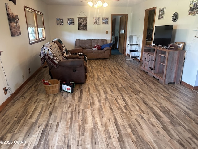 1793 8000th Rd, Oswego, KS 67356 - living area with baseboards, a ceiling fan, and wood finished floors