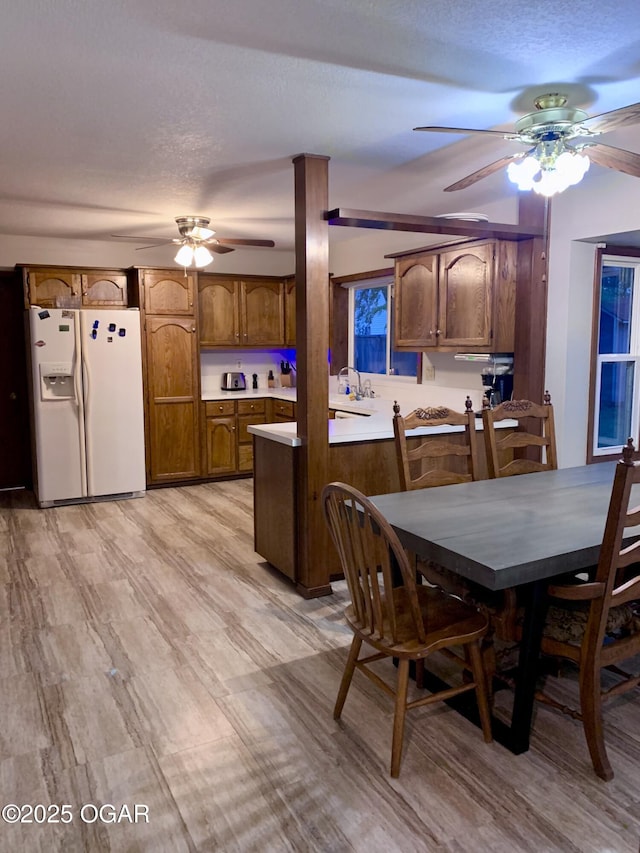 dining space with a ceiling fan and a textured ceiling