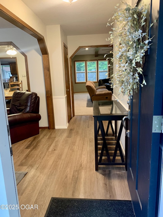 hallway featuring baseboards and wood finished floors