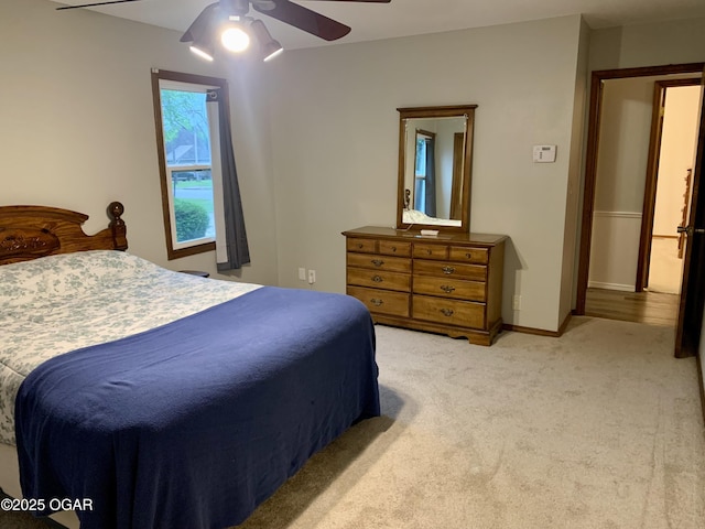 bedroom with ceiling fan and light carpet