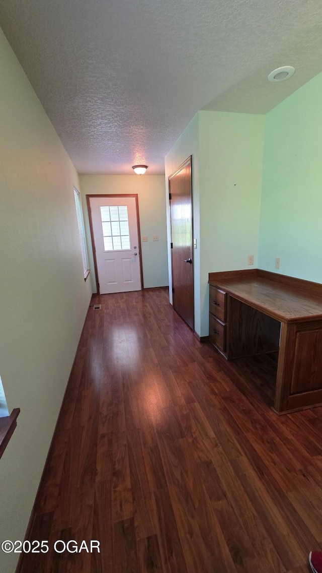 3031 S Monroe Ave, Joplin, MO 64804 - doorway to outside featuring a textured ceiling and dark wood-style flooring