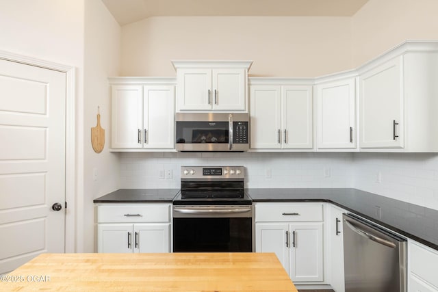 2006 Eagle Dr, Neosho, MO 64850 - kitchen featuring stainless steel appliances, tasteful backsplash, white cabinetry, lofted ceiling, and butcher block countertops