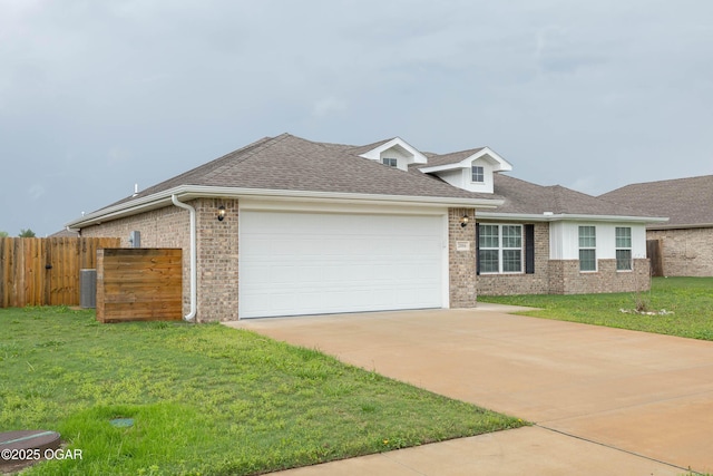 2006 Eagle Dr, Neosho, MO 64850 - view of front of home with a garage, brick siding, concrete driveway, roof with shingles, and central AC unit