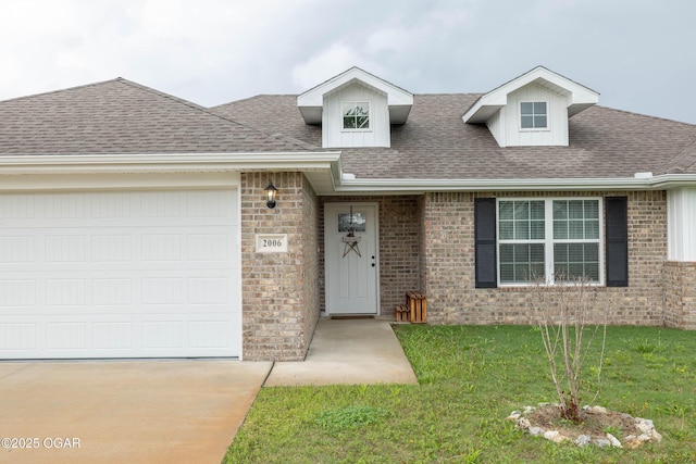 2006 Eagle Dr, Neosho, MO 64850 - view of front of property with driveway, brick siding, roof with shingles, and a front lawn