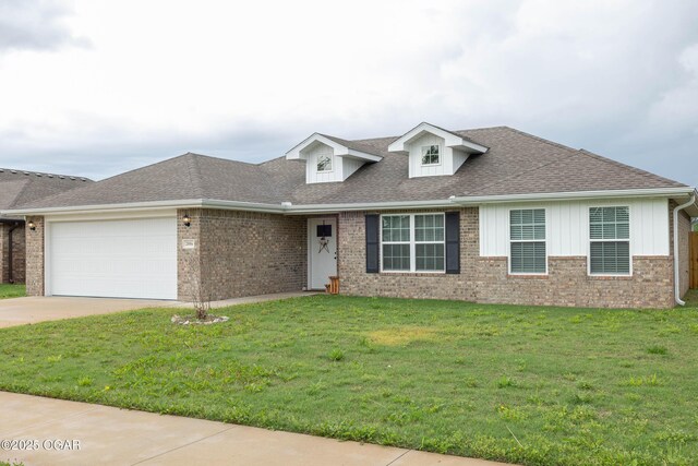 2006 Eagle Dr, Neosho, MO 64850 - view of front of property featuring a garage, a front yard, concrete driveway, and brick siding