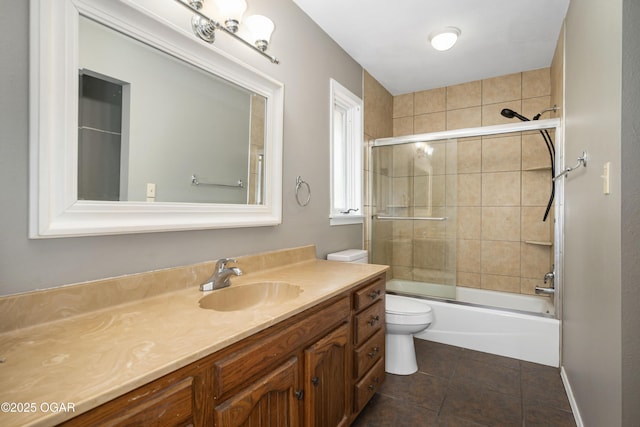 full bath featuring vanity, enclosed tub / shower combo, tile patterned flooring, and toilet