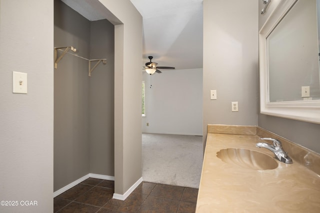 bathroom featuring a ceiling fan, baseboards, tile patterned flooring, and vanity