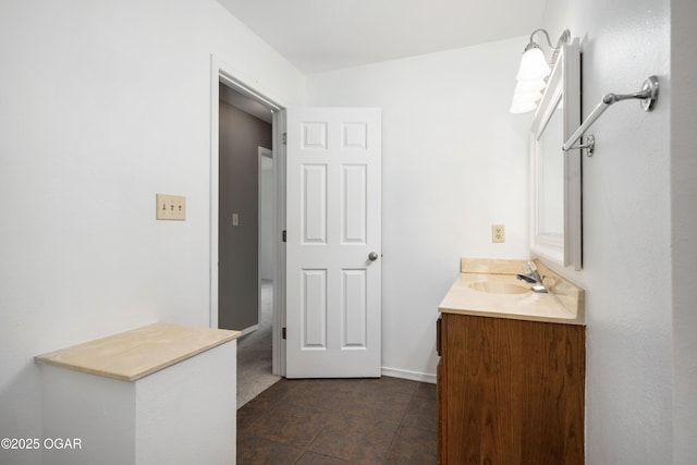 bathroom with baseboards, tile patterned flooring, and vanity