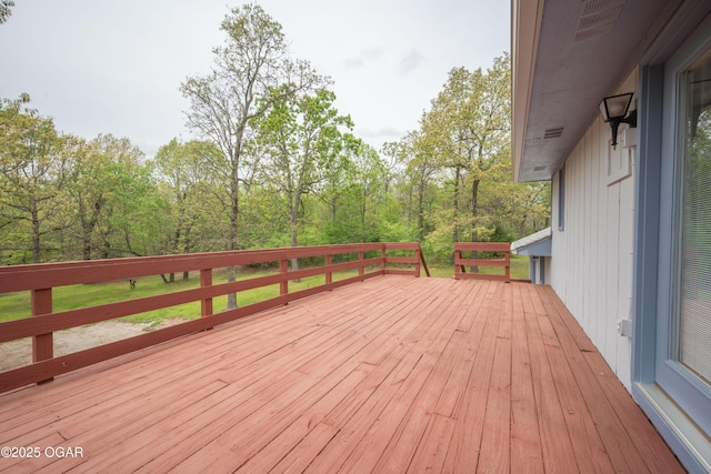 wooden deck with a forest view