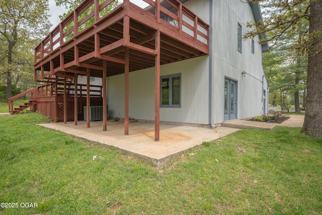 rear view of property with a patio, a yard, a deck, and stairway